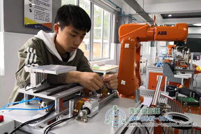 圖為某學(xué)生在學(xué)習(xí)工業(yè)機(jī)器人操作的照片 圖為某學(xué)生在學(xué)習(xí)工業(yè)機(jī)器人操作的照片